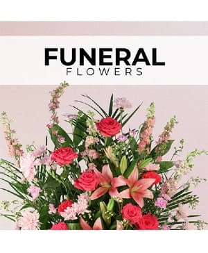 A Cameron's Flower Shop sympathy arrangement on the design counter