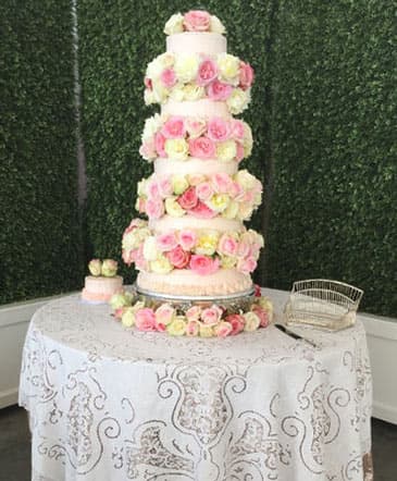 A Cameron's Flower Shop wedding cake with a flower waterfall topper